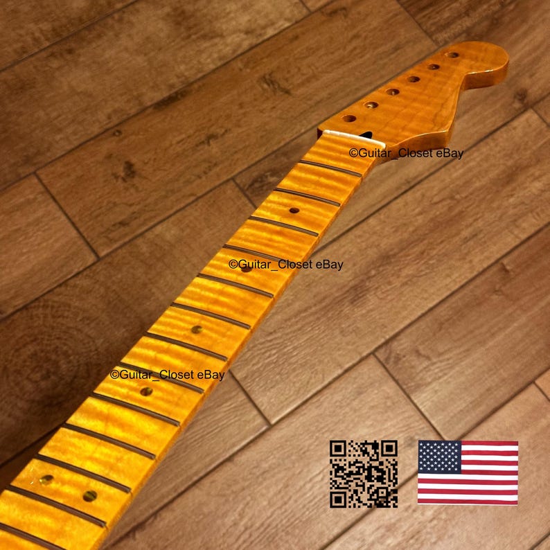May include: A maple guitar neck with a flamed grain pattern. The neck has a natural finish and features fret markers and tuning peg holes. The text "Guitar_Closet eBay" is visible on the neck. The American flag and a QR code are in the image.