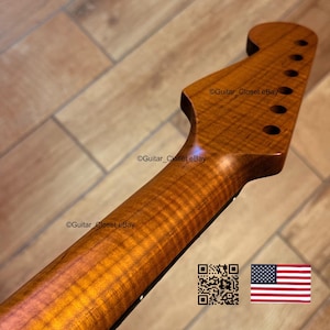 May include: A close-up of a guitar neck with a headstock. The neck is made of wood with a warm, amber finish and a prominent wood grain pattern. The headstock has tuning peg holes. The image includes the text "Guitar_Closet eBay", a QR code, and an American flag.