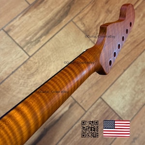 May include: A guitar neck with a flamed maple finish. The headstock has six tuning peg holes. The neck has a dark stripe down the center. The image includes a QR code and the American flag.
