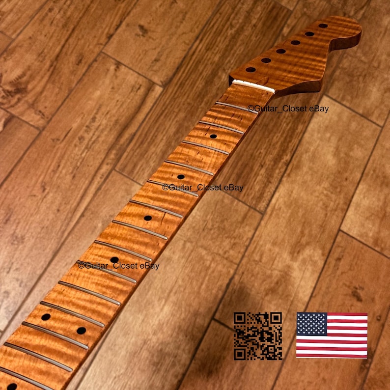 May include: A guitar neck featuring a light brown flamed maple wood grain finish, a white nut, and dark circular fret markers. The headstock includes six pre-drilled holes for tuning pegs. The text Guitar_Closet eBay appears on the surface.