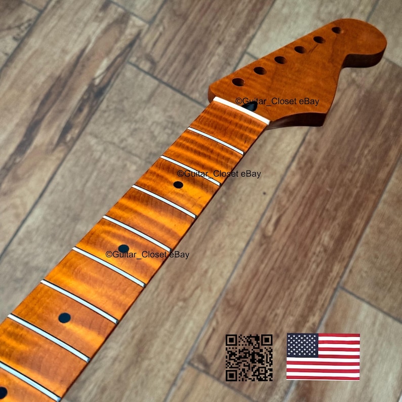May include: A guitar neck with a flamed maple fretboard. The neck is a warm amber color with white fret markers and a headstock with tuning peg holes. The fretboard has a striped pattern. The image includes a QR code and an American flag.