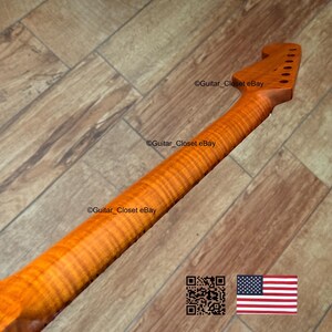 May include: A close-up of a guitar neck with a flamed maple finish. The neck is a warm amber color with visible wood grain. The headstock has tuning peg holes. The image includes the text "Guitar_Closet eBay" and a QR code and American flag.