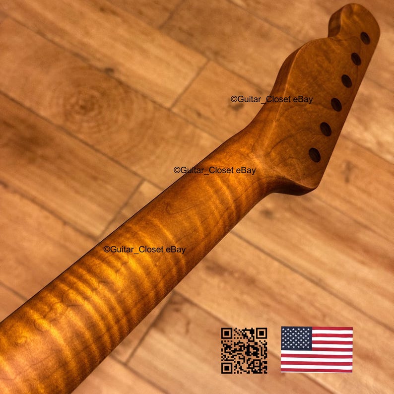 May include: A guitar neck with a flamed maple grain pattern. The wood has a warm, amber hue. The headstock features six tuning peg holes. The image includes a QR code and the American flag.