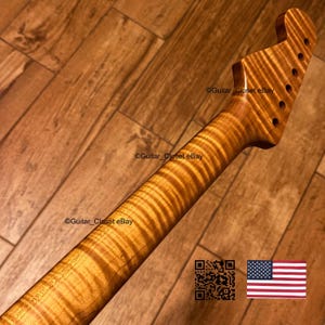 May include: A guitar neck crafted from amber-toned flamed maple wood featuring a distinct tiger-stripe grain pattern. The headstock includes six pre-drilled holes for tuning pegs. The text Guitar_Closet eBay appears multiple times on the image.