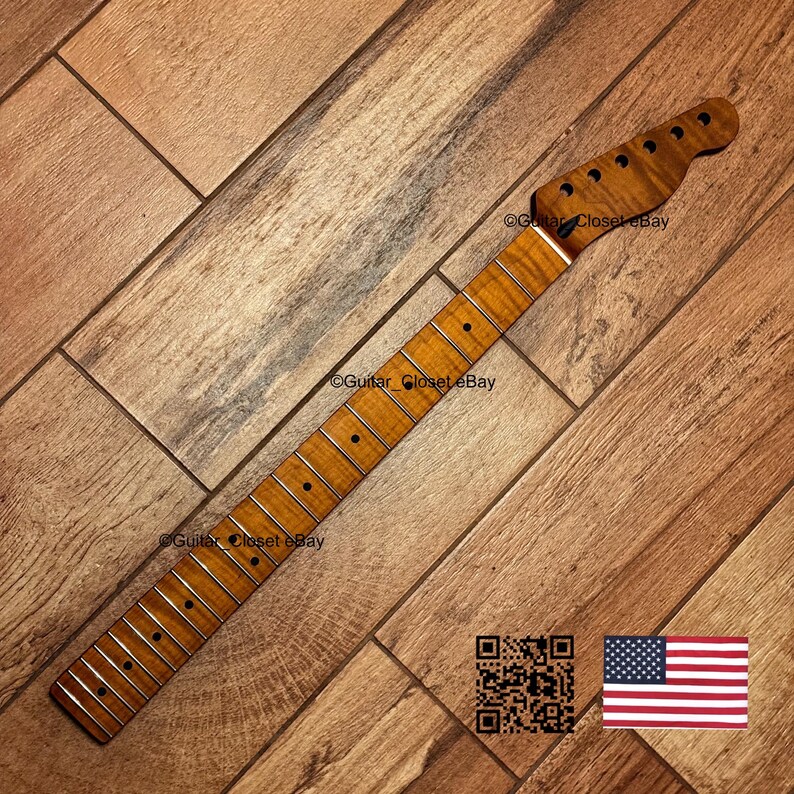 May include: A guitar neck with a natural wood finish. The neck has frets, tuning peg holes, and a headstock. The image includes a QR code and an American flag.
