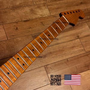 May include: A guitar neck with a flamed maple finish. The neck has a headstock with tuning peg holes and a fretboard with inlaid fret markers. The image includes a QR code and an American flag.