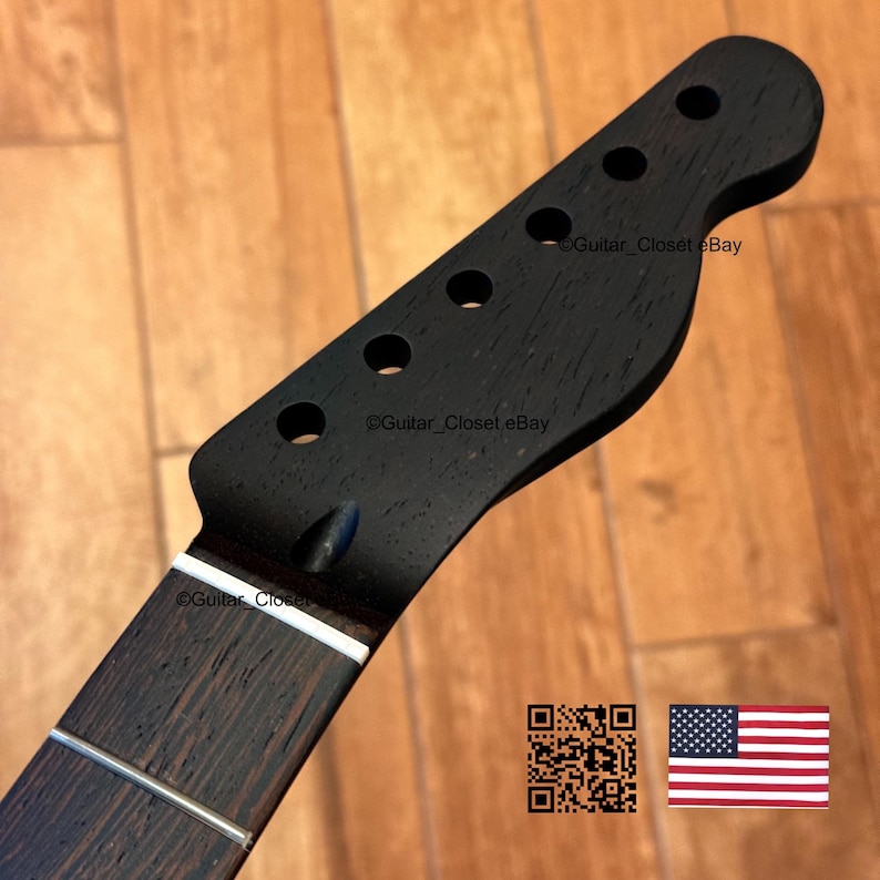 May include: A black guitar neck with six tuning peg holes and a dark wood fretboard. The headstock has a classic shape. The image includes a QR code and a small American flag.