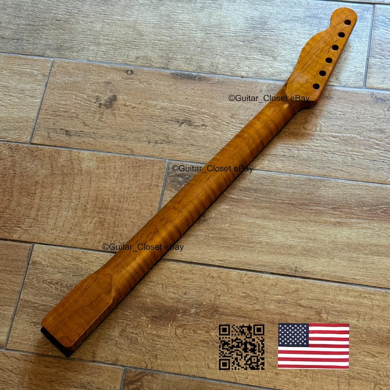 May include: A wooden guitar neck with a natural finish. The neck has a headstock with tuning peg holes and a fretboard. The wood grain is visible. The text "Guitar Closet eBay" is printed on the neck.