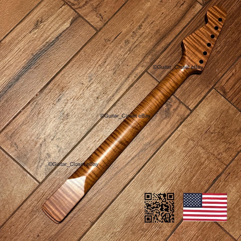May include: A guitar neck made of flamed maple wood with a natural brown finish. The headstock features six pre-drilled holes for tuning pegs. The text Guitar_Closet eBay is visible on the wood surface, along with a QR code and a small US flag icon.
