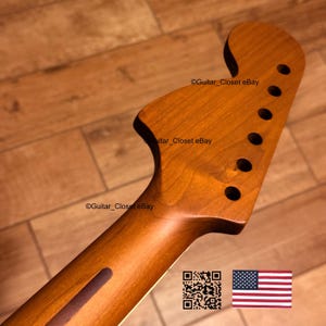 May include: A wooden guitar neck with a natural finish. The headstock features six tuning peg holes. The neck has a dark brown stripe down the center. The image includes the text "Guitar_Closet eBay" and a QR code.