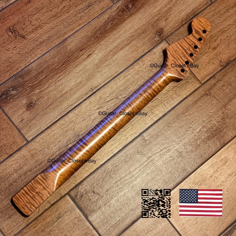 Puede incluir: Un m&aacute;stil de guitarra fabricado en madera de arce flameado con un patr&oacute;n de veteado de rayas de tigre. El clavijero presenta seis orificios pretaladrados para las clavijas. El texto Guitar_Closet eBay es visible en la madera junto a un c&oacute;digo QR.