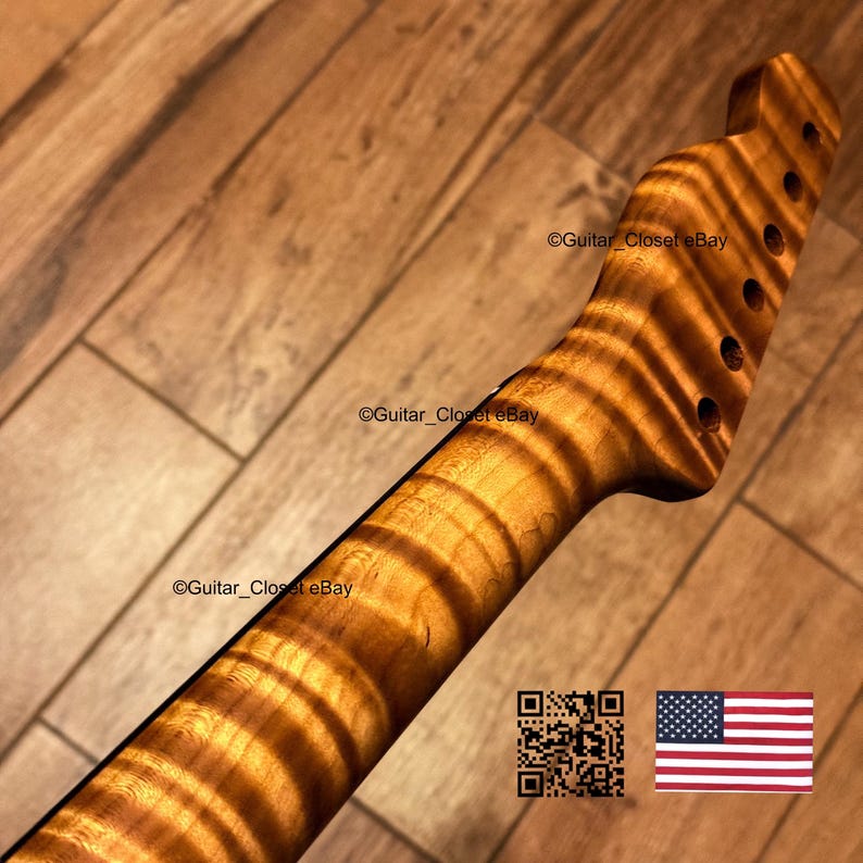 May include: A guitar neck featuring a prominent tiger stripe flame maple wood grain pattern with a natural amber finish. The headstock includes six pre-drilled tuning peg holes. The text Guitar_Closet eBay appears on the neck and headstock.
