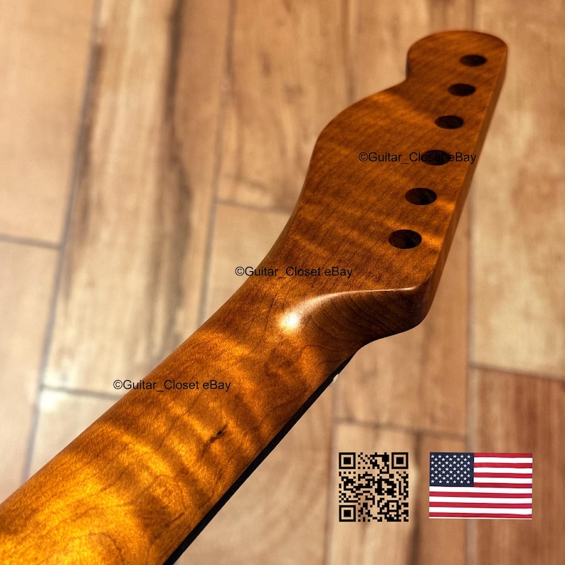 May include: A close-up of a guitar neck with a natural wood finish. The headstock has six tuning peg holes. The wood grain is visible, and the neck has a smooth, curved shape. The text "Guitar_Closet eBay" is visible.
