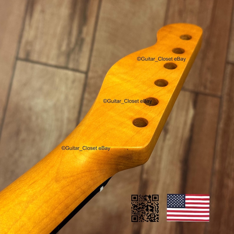 Puede incluir: Primer plano de un m&aacute;stil de guitarra con acabado de madera natural. El clavijero tiene seis agujeros para las clavijas y el texto "Guitar_Closet eBay". La bandera americana est&aacute; en la esquina inferior derecha.