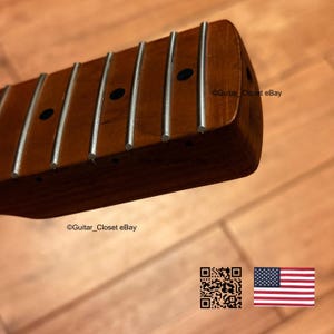 Puede incluir: Un m&aacute;stil de guitarra con un diapas&oacute;n de madera de color marr&oacute;n medio, trastes de metal plateado y marcadores de posici&oacute;n circulares oscuros. El texto Guitar_Closet eBay es visible en la madera, junto a un c&oacute;digo QR y una bandera estadounidense.