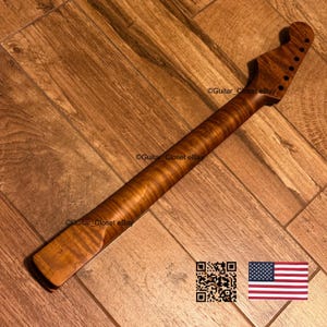 May include: A guitar neck crafted from wood with a prominent flame maple grain pattern. The headstock features six pre-drilled holes for tuning pegs. The text Guitar_Closet eBay is visible on the surface, along with a QR code and a small US flag.