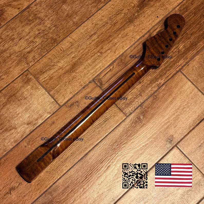 May include: A guitar neck with a dark brown, flamed maple finish. The neck has a headstock with tuning peg holes and a fretboard with a dark stripe. The image includes a QR code and an American flag.