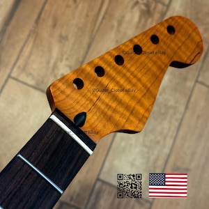 May include: A guitar neck with a flamed maple headstock and a dark rosewood fretboard. The headstock has six tuning peg holes and a natural finish. The fretboard has silver frets and white binding. The text "Guitar Closet eBay" is visible.