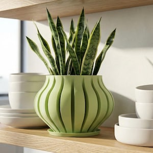 May include: A set of three ceramic mugs with a speckled, matte finish. Each mug features a different color: light blue, cream, and gray. The mugs have a simple, modern design and a comfortable handle.