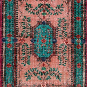 May include: A rectangular area rug featuring a salmon pink central field with a teal octagonal medallion. The design includes green leafy vine motifs, red and blue floral patterns, and a wide border in teal and magenta with floral accents.