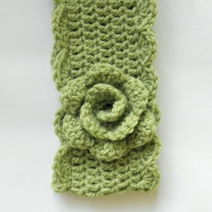 May include: A green crocheted headband with a large green crocheted flower.