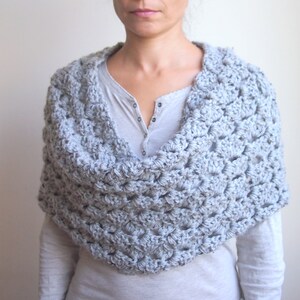 May include: A set of three ceramic nesting bowls in graduating sizes. The bowls are white with a blue floral pattern and a scalloped edge. The largest bowl is approximately 8 inches in diameter.