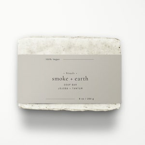 May include: A bar of soap with a label that reads "Rituals. smoke + earth SOAP BAR JOJOBA + TANTUM 8 oz / 250 g" and "100% Vegan".
