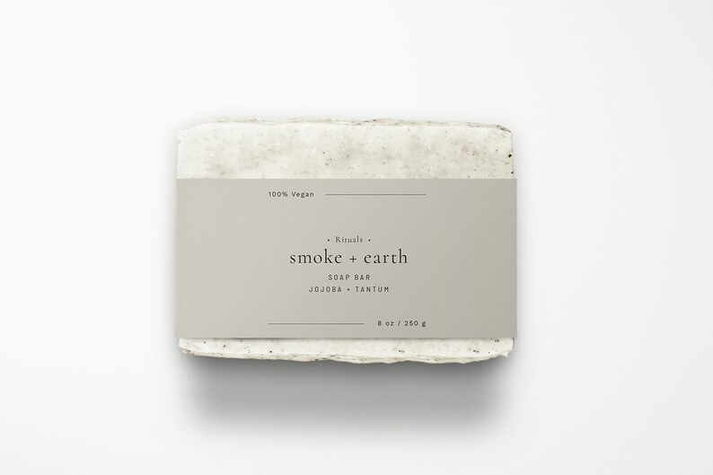 May include: A bar of soap with a label that reads "Rituals. smoke + earth SOAP BAR JOJOBA + TANTUM 8 oz / 250 g" and "100% Vegan".