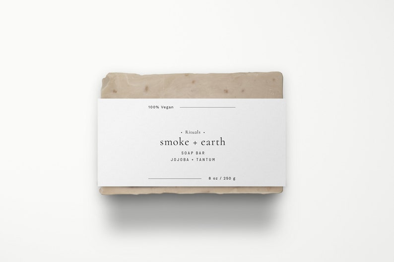 May include: A white bar of soap with a label that reads "Rituals. smoke + earth SOAP BAR JOJOBA + TANTUM 8 oz / 250 g 100% Vegan".