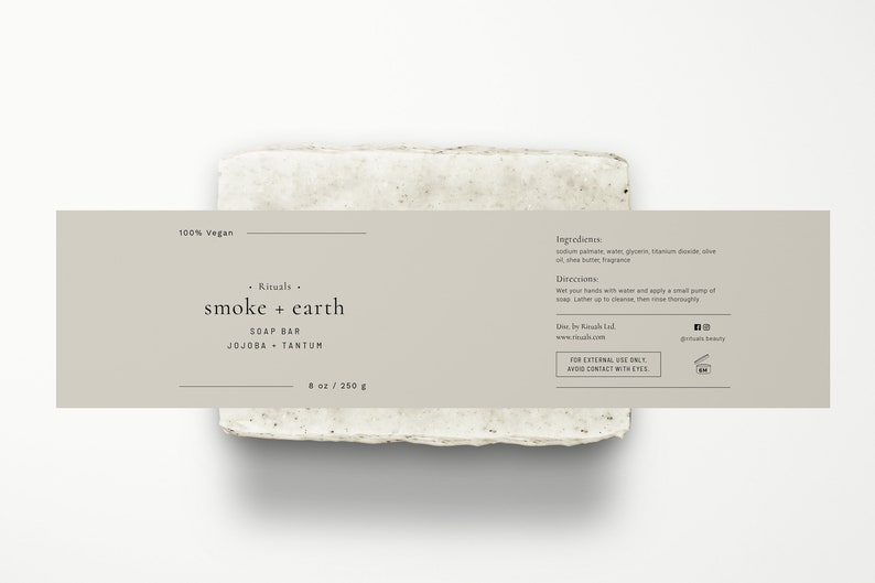 May include: A rectangular bar of soap with a light gray color and a speckled texture. The label reads "Rituals smoke + earth SOAP BAR JOJOBA + TANTUM 8 oz / 250 g". The label also states "100% Vegan" and includes ingredients and directions for use.