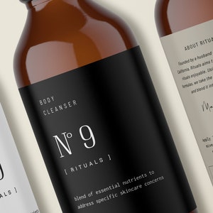 May include: Two amber glass bottles with black and white labels. The labels read "Body Cleanser N&deg; 9 [Rituals]" and "About Rituals". The bottle on the right has additional text about the product and how to use it.