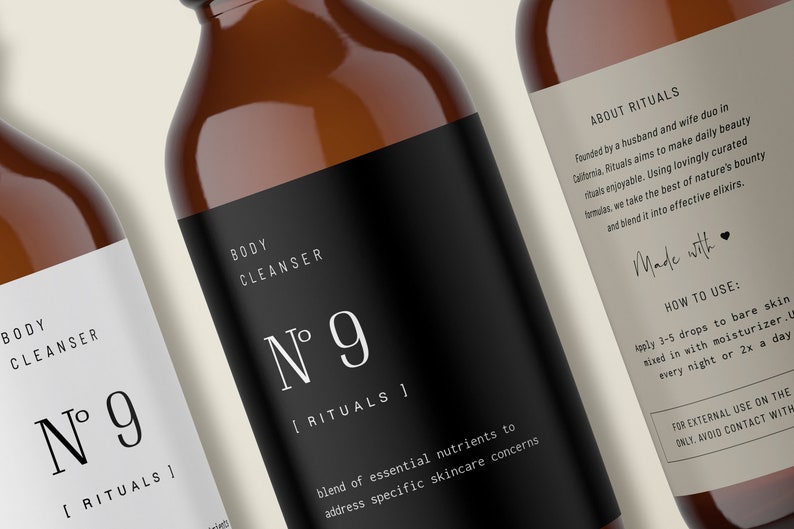 May include: Two amber glass bottles with black and white labels. The labels read "Body Cleanser N&deg; 9 [Rituals]" and "About Rituals". The bottle on the right has additional text about the product and how to use it.