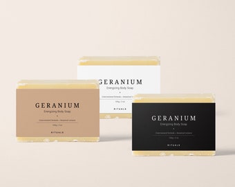 May include: Three bars of Geranium Energizing Body Soap, each with a different label color: tan, white, and black. The labels display the product name, description, and brand. Each bar is 100g / 3 oz.