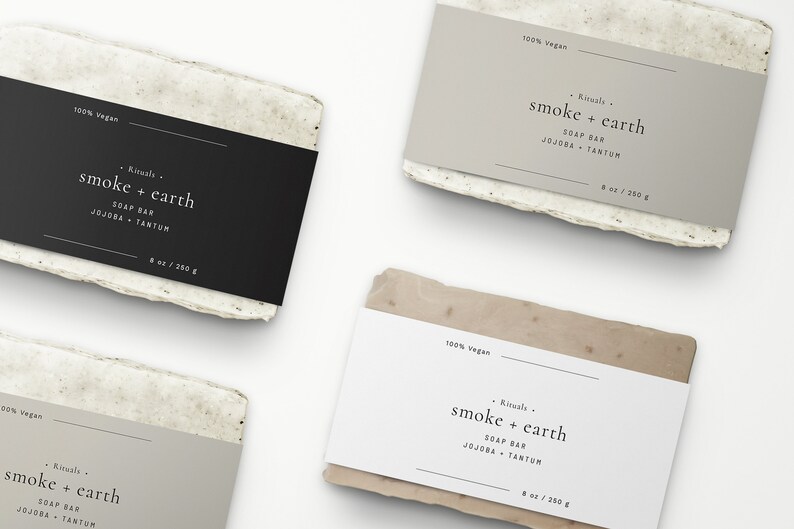 May include: Three rectangular bars of soap with labels that read "100% vegan" and "Rituals - smoke + earth SOAP BAR JOJOBA + TANTUM 8 oz / 250 g". The soap bars are wrapped in white paper with a textured surface.
