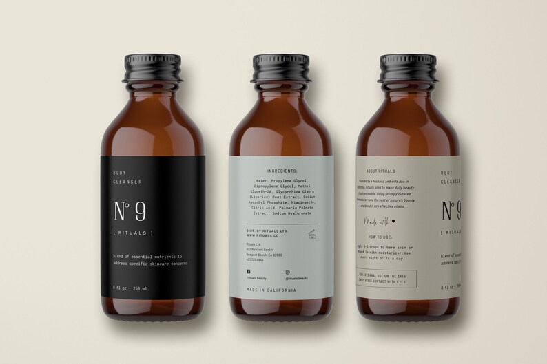 May include: Three amber glass bottles with black lids and labels. The labels are white with black text and the words "Body Cleanser N&deg; 9 Rituals". The middle bottle has a label with the ingredients listed. The bottle on the right has a label with the text "About Rituals" and "How to Use".