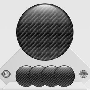 May include: Four carbon fibre-style round decals, with a larger one above. The decals have a glossy finish and a woven pattern. The image also includes a warranty badge and a custom-made badge.