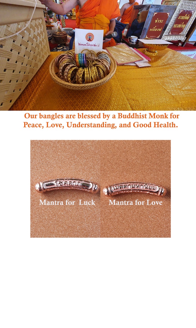 May include: A close-up of two gold-colored metal bangles with engraved Thai script. The bangle on the left is labeled "Mantra for Luck" and the bangle on the right is labeled "Mantra for Love".