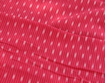 May include: Red fabric with a white geometric pattern. The fabric has a subtle sheen and a soft texture.