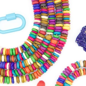 May include: A colorful beaded necklace with a tassel. The beads are made of various materials, including wood, stone, and glass. The necklace is a vibrant mix of colors, including red, orange, yellow, green, blue, purple, and white.