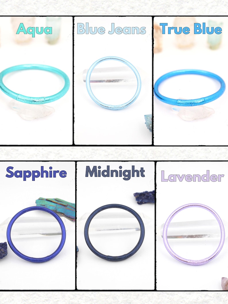 May include: A collection of six colorful, round bracelets in shades of aqua, blue jeans, true blue, sapphire, midnight, and lavender. Each bracelet is displayed against a white background with the color name above it.