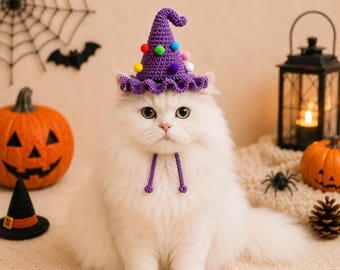 May include: A purple crocheted witch hat for a pet, featuring a pointed top, a ruffled brim, and small colorful pom-poms attached to the exterior. The hat includes two thin, matching purple crocheted chin straps that hang down from the brim.