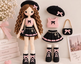 May include: A crochet doll with long brown hair wearing a black beret, pink crop top, black pleated skirt, and black boots with pink laces. Includes a separate black beret, pink top, black skirt, and black handbag with a gold chain strap.