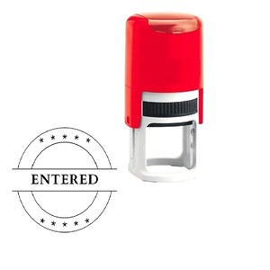 May include: A red and white "ENTERED" stamp with a black ink pad. The stamp has a rectangular design with a handle and a circular stamp with the word "ENTERED" in the centre.