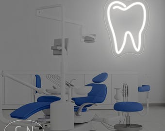 May include: A dental office interior featuring a blue and white dental chair, a small blue stool, and various dental tools. A white neon sign in the shape of a tooth is mounted on the wall. The image has a clean, modern aesthetic.