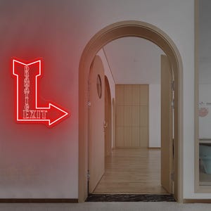 May include: A red neon sign in the shape of an arrow with the words "DRAMATIC" stacked vertically and "EXIT" horizontally. The sign is mounted on a light pink wall. The background shows an open doorway and a hallway.