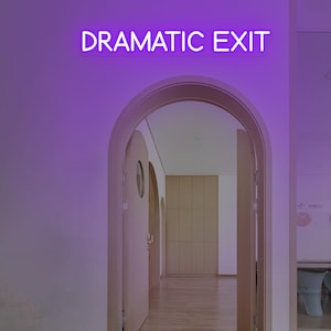 May include: A neon sign with the words "DRAMATIC EXIT" in white letters is mounted above an arched doorway. The sign glows with a purple light, casting a purple hue on the wall. The doorway leads to a hallway with wooden doors and a light-colored floor.