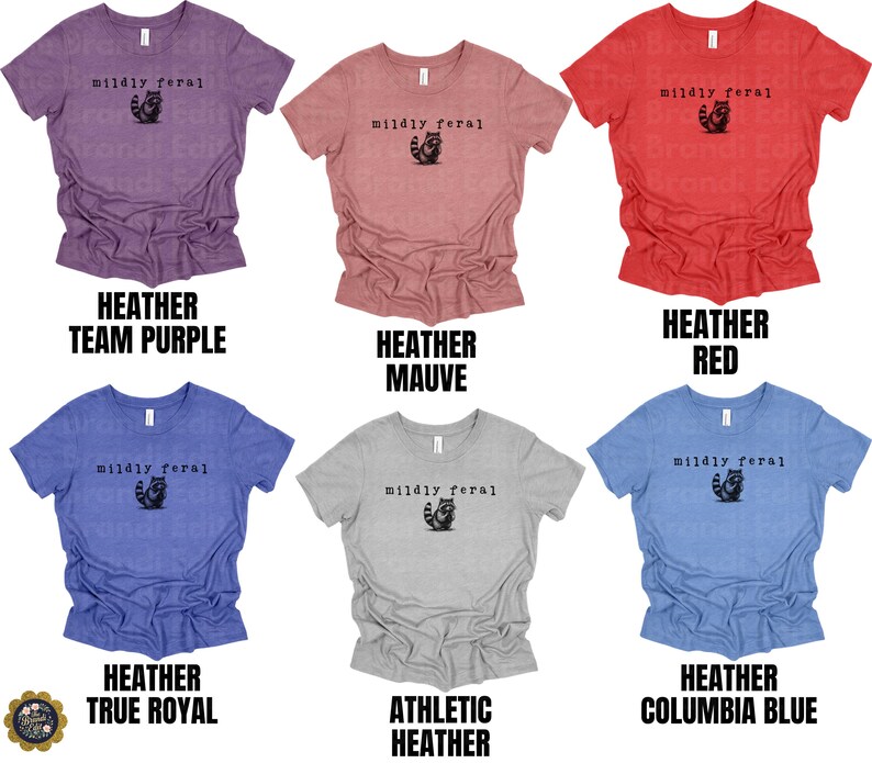 Puede incluir: Seis camisetas de manga corta y cuello redondo en colores heather team purple, heather mauve, heather red, heather true royal, athletic heather y heather columbia blue. Cada una tiene el texto negro "mildly feral" sobre un peque&ntilde;o gr&aacute;fico de un mapache.