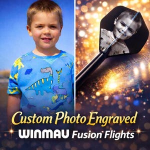 May include: A young boy in a blue dinosaur-themed shirt is featured next to a dart with a photo of the same boy. The dart flight is black with a photo of the boy. Text reads "Custom Photo Engraved WINMAU Fusion Flights."