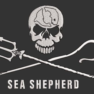 May include: Embroidered patch featuring a white skull with a map design on the forehead, crossed trident and a curved staff. The text "SEA SHEPHERD" is embroidered below the crossed weapons on a dark gray background.