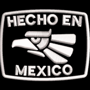 May include: A white embroidered patch featuring the text "HECHO EN MEXICO" and an eagle design on a black background. The eagle is depicted in a geometric style.